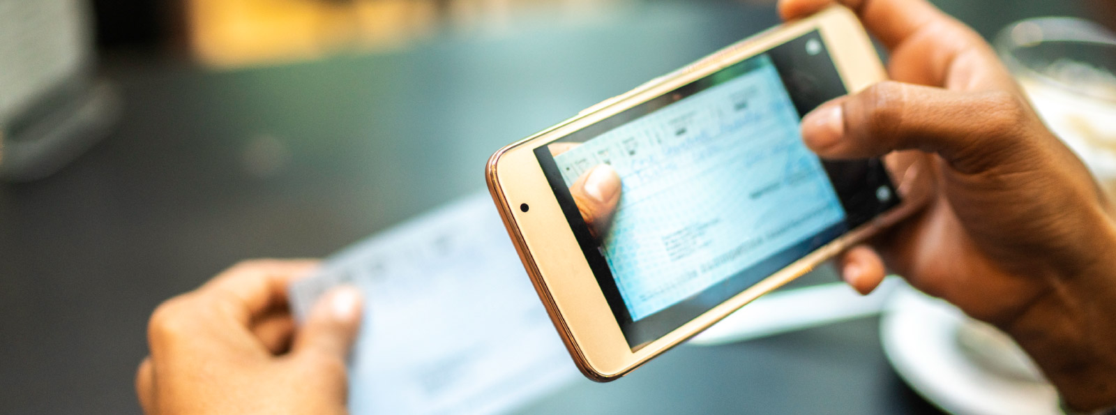 Person holding phone taking a picture of a check for remote deposit