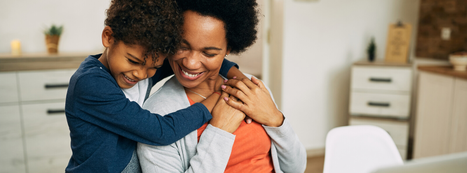 A young kid hugging mom