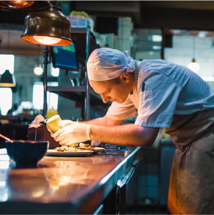 A chef in an industrial kitchen