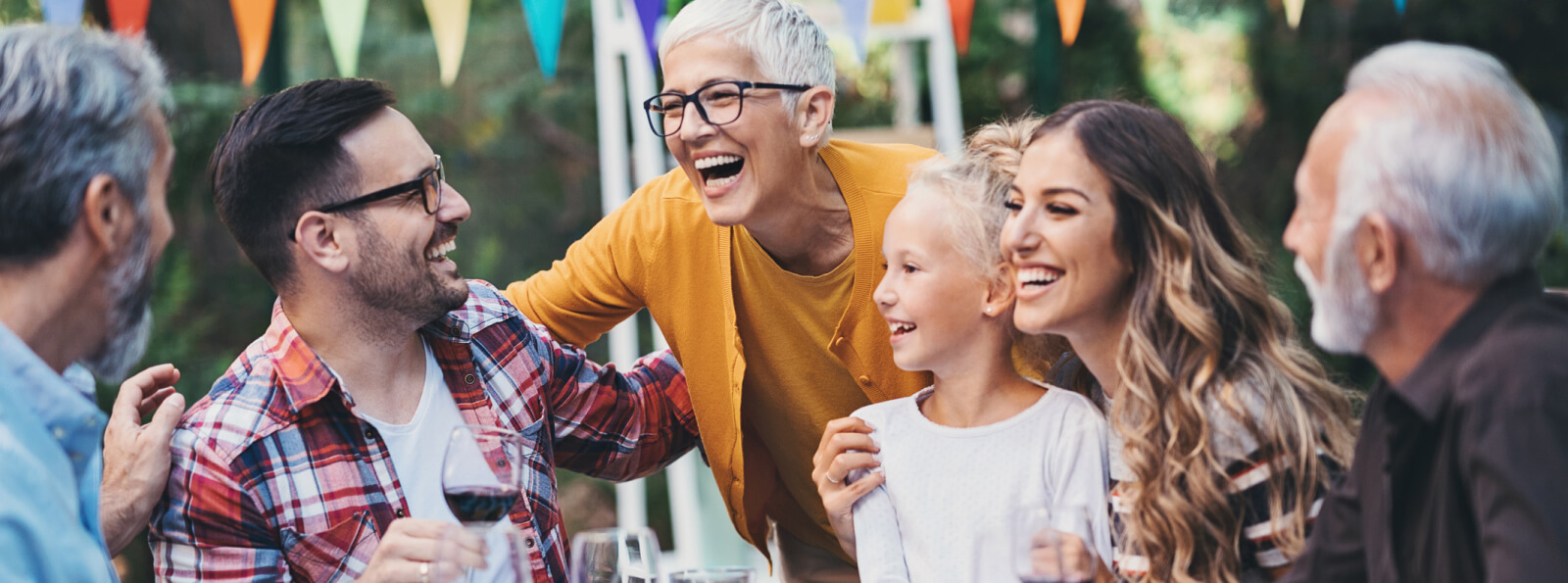 A large family laughing and talking around a table