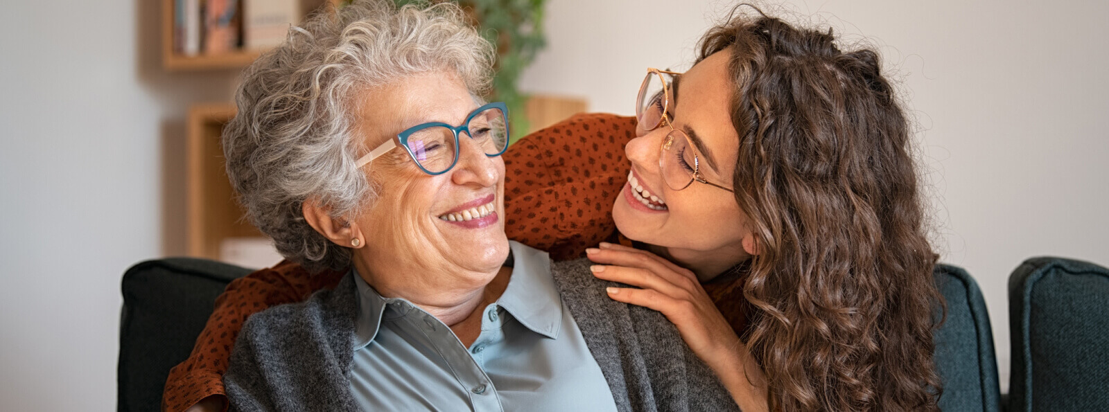 A young woman and an older woman smiling at each other